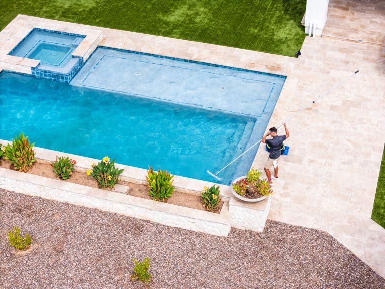 Swimhappy pool service tech cleaning a pool